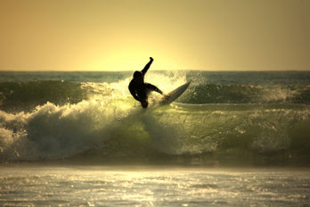 Surfer at sunset, Malibu, CA