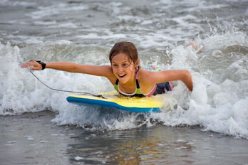 girl in the surf on a boogie board